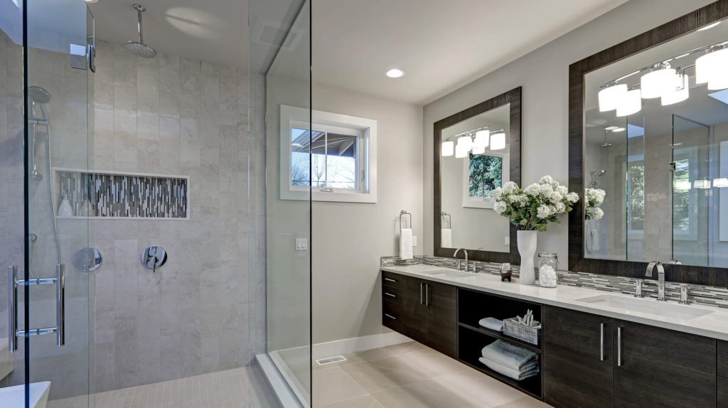 A bathroom with a large glass shower door.